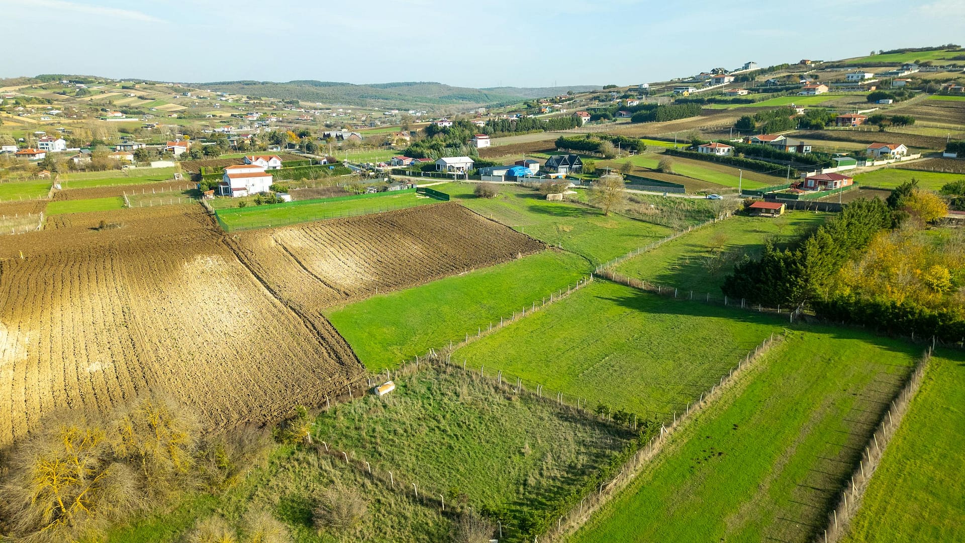 Vibrant aerial view of rural farmland in Turkey during springtime, showcasing lush green fields.